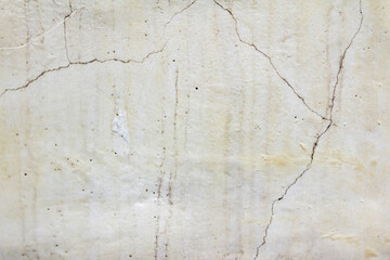 Close-up photo texture of worn and cracked marble wall.
