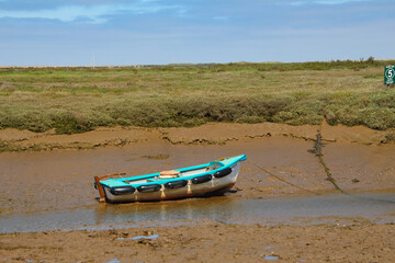 Fototapeta premium Boat stranded during low tide, norfolk, morston quay, boat, low tide, Blakeney, National Nature Reserve, Blakeney quay, National, Nature, Reserve