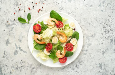 Fresh seafood salad. Grilled shrimp, fresh vegetable salad and egg. Fried shrimps. Healthy food on stone background