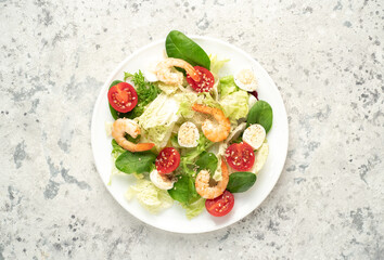 Fresh seafood salad. Grilled shrimp, fresh vegetable salad and egg. Fried shrimps. Healthy food on stone background
