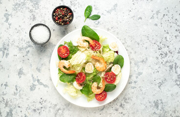 Fresh seafood salad. Grilled shrimp, fresh vegetable salad and egg. Fried shrimps. Healthy food on stone background