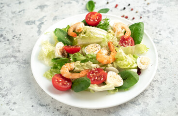 Fresh seafood salad. Grilled shrimp, fresh vegetable salad and egg. Fried shrimps. Healthy food on stone background