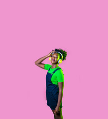 young black woman looking over listening music wireless headphones smiling happy and serene