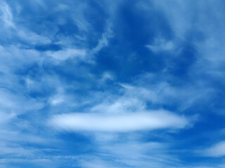Blue sky with fluffy white clouds, neutral background for your artwork