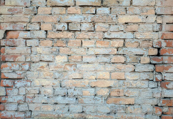 Old light tone multicolored brick wall texture closeup