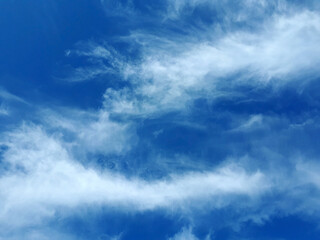 Blue sky with fluffy white clouds, can be used as background