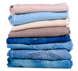 Stack folded sweaters and jeans on white background isolation