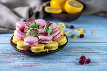 yellow pink green macaroons with raspberries and lemon