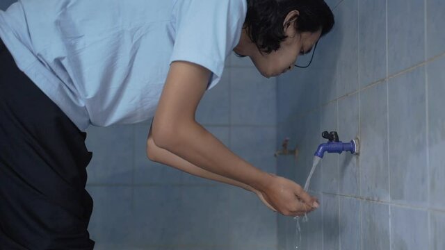 Man muslim perform ablution wudhu washing hand
