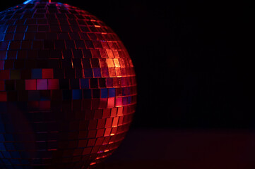 The disco ball is spinning in pink-blue smoke. Night life.