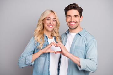 Photo of adorable sweet young people wear denim shirts showing fingers heart smiling isolated grey color background