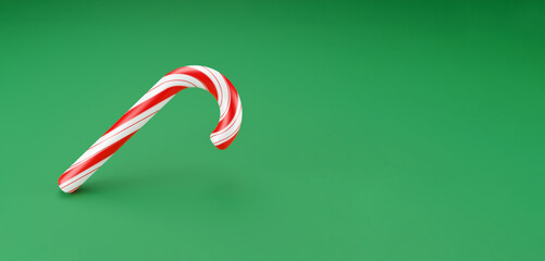 Merry Christmas canes, lollipop mint candy with red stripes on green background. New Years celebration concept. Traditional sweet dessert. 3d render