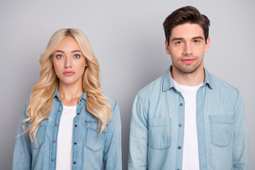 Photo of two young business people serious confident wear jeans shirt isolated over grey color background