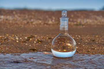 Glass flask by the sea.