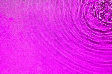 Fototapeta premium the rippling water from the top right corner texture in purple color. a background pattern of the clear liquid water for creative design.
