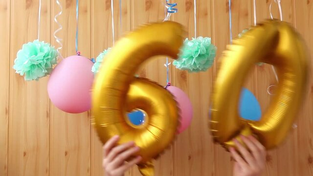 Happy sixtieth birthday with golden number sixty 60 balloons and colorful decorations, anniversary celebration