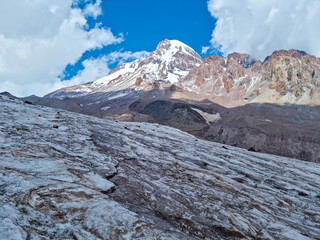 A close up on the surface of Gergeti Glacier, with the view on Mount Kazbeg, Caucasus, Georgia....