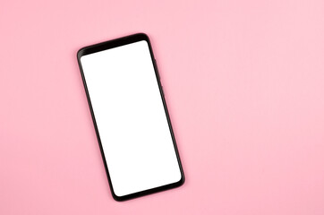 Smartphone with a white display on a pink background. Mock up mobile phone flat lay