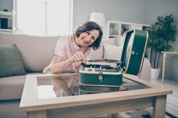 Photo of aged brunette funky lady listen music wear pink t-shirt at home alone