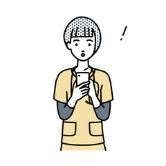 立ってスマートフォンを操作して何かに気づいて驚いた看護師の女性