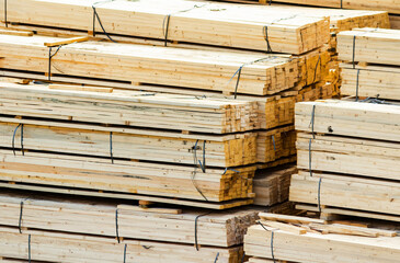 Photo of packed stacks of wooden planks and boards.