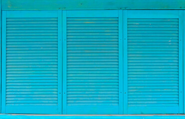 Texture photo of horizontal worn blue paint colored wooden wooden shades.
