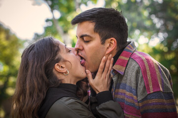 Close-up of French kiss. Couple in love hugging and kissing