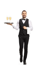 Full length portrait of a smiling waiter carrying a silver tray with white wine glasses