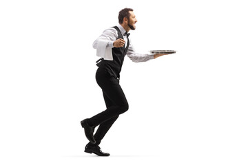 Full length profile shot of a waiter running with a silver tray