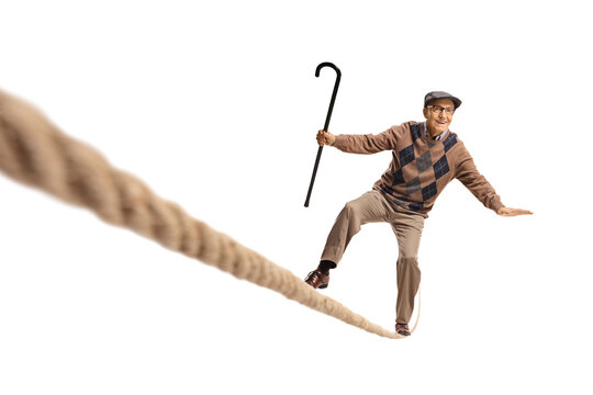 Elderly man standing on a rope and keeping balance