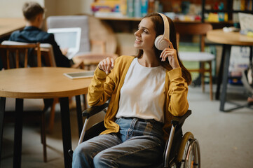 Disabled student listen to music in headphones