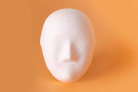 white Venetian mask on a beige background. The concept of the theater. Hypocrisy