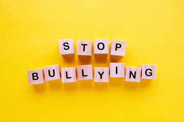 Obraz premium Stop Bullying wooden blocks with letters on yellow background