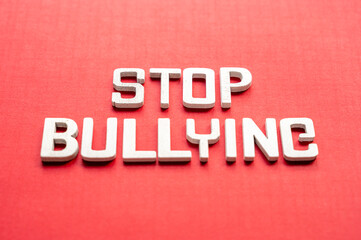 Stop bullying white words on red background, top view