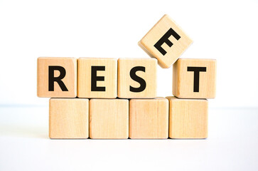 Reset symbol. The concept word 'reset' on wooden cubes. Beautiful white table, white background. Business and reset concept. Copy space.