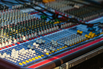 Recording console. A sound engineer's mixing desk at a music festival.