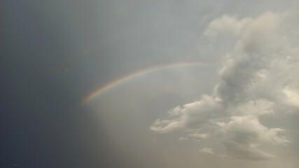 Fototapeta premium rainbow between clouds and black sky