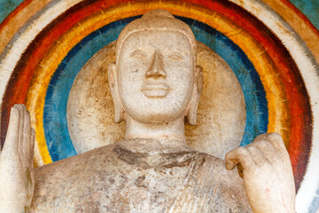 White stone Buddha statue with halo behind his head inside of the Ruwanwelisaya Dagoba in...