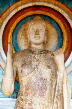 White stone Buddha statue with halo behind his head inside of the Ruwanwelisaya Dagoba in Anuradhapura, Sri Lanka, Asia