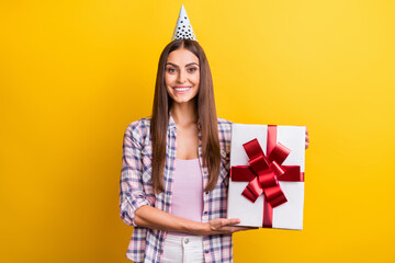 Photo of young woman happy positive smile get present box birthday party isolated over yellow color background