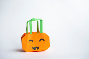 pumpkin craft origami bag on white background, halloween decoration