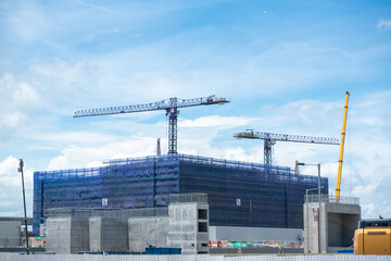 city landscape architecture industry building construction site, project of business engineering development work field, professional safety equipment and contractor in background