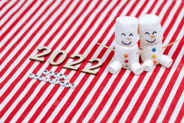 New Year and Merry Christmas 2022. Pair of marshmallows snowmen. New Year theme.