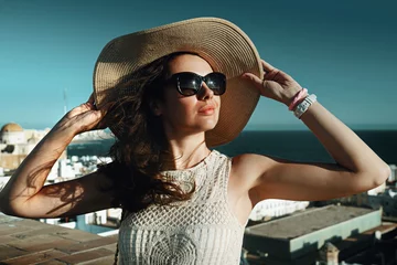 Foto op Plexiglas anti-reflex Happy young woman with straw hat enjoying her summer holidays © konradbak