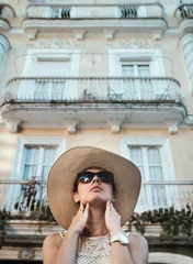 Deurstickers Happy young woman with straw hat enjoying her summer holidays © konradbak