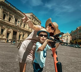 Foto op Canvas Young mother and her son on vacation in the city © konradbak