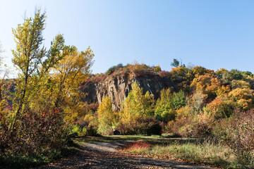 Fototapeta premium Old quarry. Rocks and yellow trees