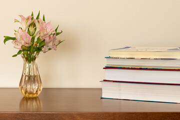 books and flower pot on the table