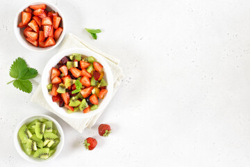Fruit salad from kiwi and strawberry in bowl