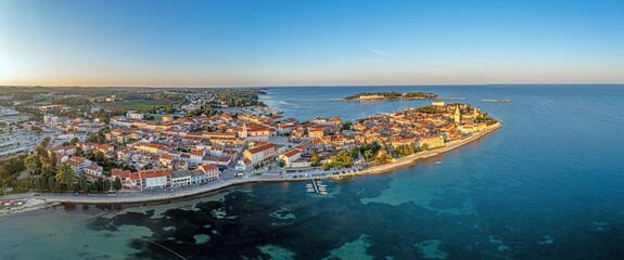 Drone panorama of Croatian coastal town Porec with harbor and promenade during sunrise © Aquarius
